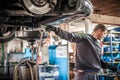 Mechanic discharges motor oil from engine tank under the car Royalty Free Stock Photo