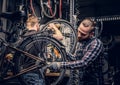 Mechanic doing bicycle wheel service manual in a workshop. Royalty Free Stock Photo