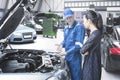 Mechanic explaining repair cost to his client Royalty Free Stock Photo