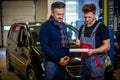 Mechanic explains car reparing plan to a client Royalty Free Stock Photo