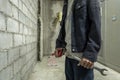 Mechanic in the factory standing Metal wrench on the background of the factory