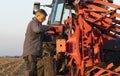 Mechanic fixing plow on the tractor Royalty Free Stock Photo