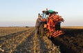 Mechanic fixing plow on the tractor Royalty Free Stock Photo