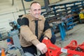 Mechanic fixing plow on tractor Royalty Free Stock Photo