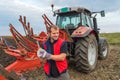 Mechanic fixing plow on the tractor Royalty Free Stock Photo