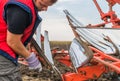 Mechanic fixing plow on the tractor Royalty Free Stock Photo