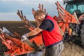 Mechanic fixing plow on the tractor Royalty Free Stock Photo