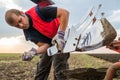 Mechanic fixing plow on the tractor Royalty Free Stock Photo