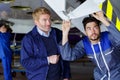 mechanic and flight engineer having discussion in hangar