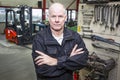 Mechanic in forklift garage Royalty Free Stock Photo