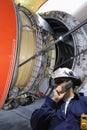 Mechanic with giant jet engine Royalty Free Stock Photo