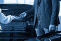 Mechanic giving car keys to customer after servicing Royalty Free Stock Photo