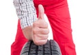 Mechanic hand on tire showing like or thumb-up