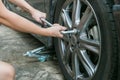 Mechanic hands changing with tool repairing the tire.