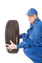 Mechanic is holding car tire on white background