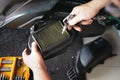 Mechanic holding dirty Engine Air Filter over big scooter and cleaning Filter with air blow gun .mechanic working in garage. Royalty Free Stock Photo