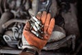 Mechanic holding old broken car spark plugs Royalty Free Stock Photo