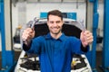 Mechanic holding pair of wrenches