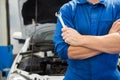 Mechanic holding wrench with crossed arms Royalty Free Stock Photo