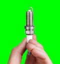 Mechanic holds a spare part spark plug in hand Royalty Free Stock Photo