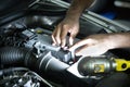 Mechanic inspect and replace car battery at garage