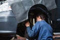 Mechanic inspecting car suspension system