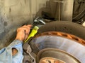 Mechanic Inspecting Wheel Well with Flashlight