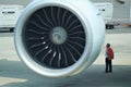 Mechanic inspects airplane engine on tarmac