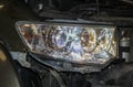 The mechanic installs the BI-LED lens in the headlight housing.