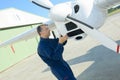 Mechanic looking at aircraft propellor