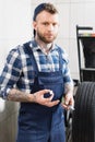 Mechanic looking at camera while holding Royalty Free Stock Photo