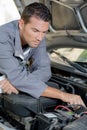 Mechanic looking at car engine