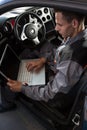 Mechanic looking at diagnostic computer