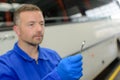 Mechanic looking at ring spanner Royalty Free Stock Photo