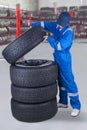 Mechanic makes a stack of tires