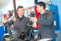 Mechanic and male trainee with dampers