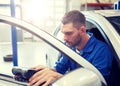 Mechanic man with diagnostic scanner at car shop Royalty Free Stock Photo