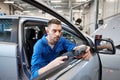 Mechanic man with diagnostic scanner at car shop Royalty Free Stock Photo