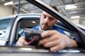 Mechanic man with diagnostic scanner at car shop Royalty Free Stock Photo