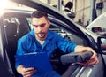 Mechanic man with diagnostic scanner at car shop Royalty Free Stock Photo