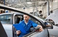 Mechanic man with diagnostic scanner at car shop Royalty Free Stock Photo