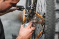 Mechanic man Hands, Spraying Oil To A Bike Chain. Bicycle maintenance.