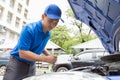 Mechanic man holding clipboard and check the car Royalty Free Stock Photo