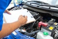 Mechanic man holding clipboard and check the car Royalty Free Stock Photo