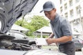 Mechanic man holding clipboard and check the car Royalty Free Stock Photo