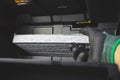 Mechanic man installing car air conditioner filter put it on the air filter slot Royalty Free Stock Photo