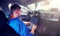 Mechanic man with laptop making car diagnostic Royalty Free Stock Photo