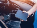 Mechanic man with laptop making car diagnostics at auto service Royalty Free Stock Photo