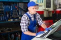 Mechanic man with laptop making car diagnostics at service Royalty Free Stock Photo