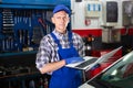 Mechanic man with laptop making car diagnostics at service Royalty Free Stock Photo